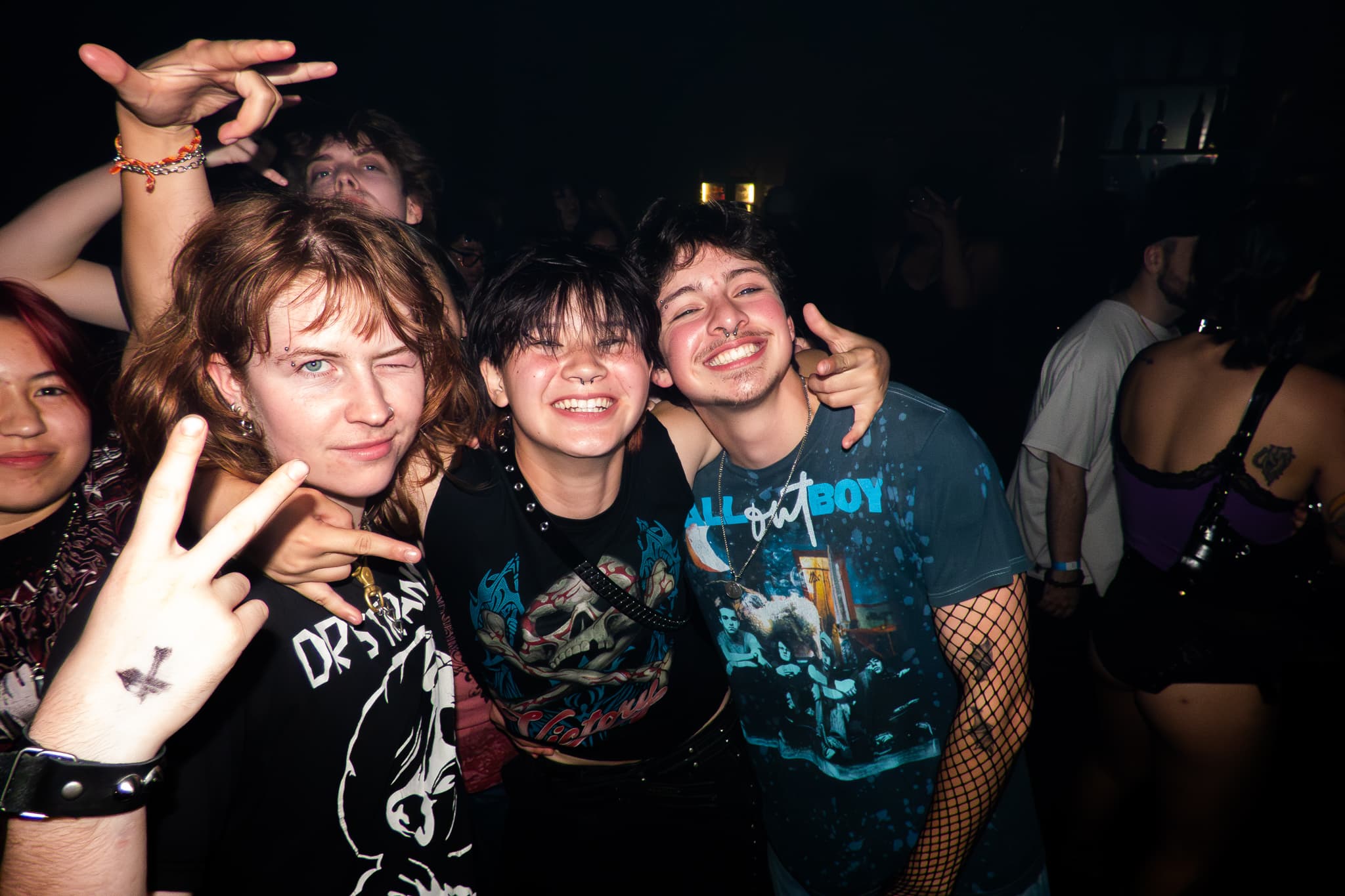 Event photography by Chase Tipton - Friends embracing and smiling in a club setting